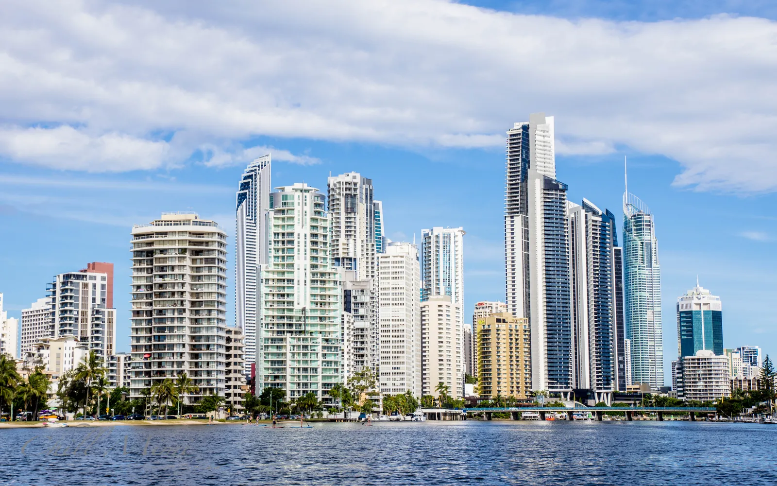 Surfers Paradise Beach in the morning, clean golden sand stretching parallel to high-rise towers and clear blue sea