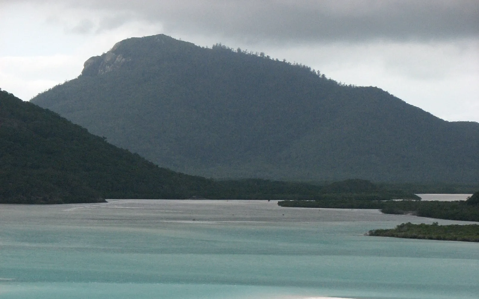 Elevated view from Hill Inlet looking down on turquoise water swirling in patterns with the white sand of Whitehaven, like a painting