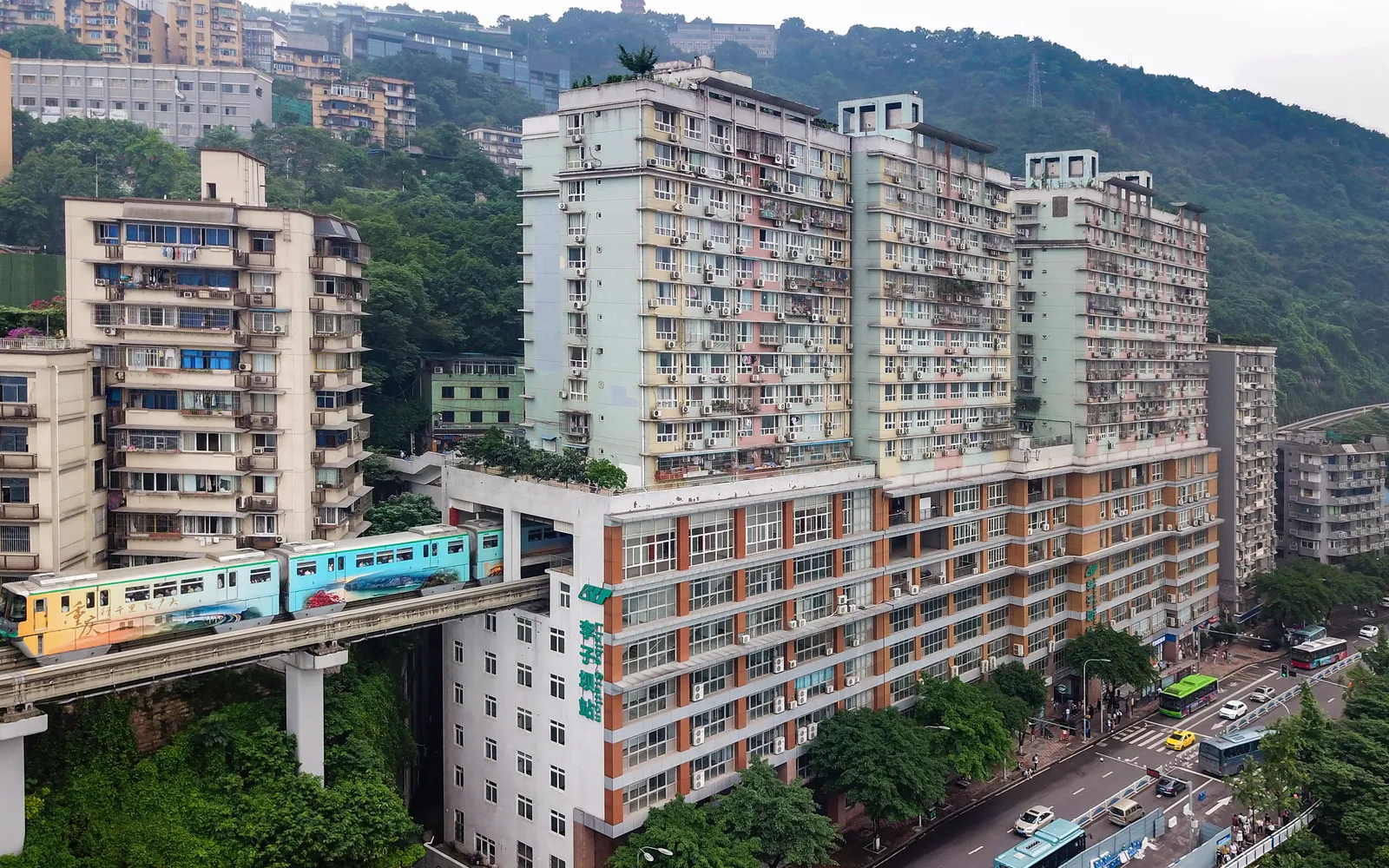The Chongqing monorail running straight through floors 6-8 of a residential building at Liziba station