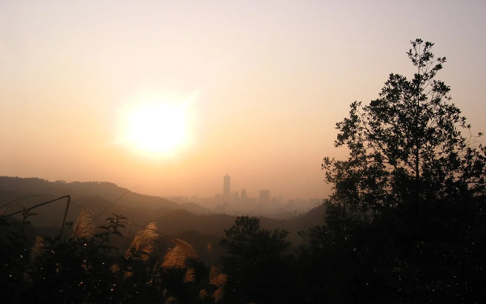 The view from the summit of Baiyun Mountain looking down over Guangzhou stretching out through light morning mist