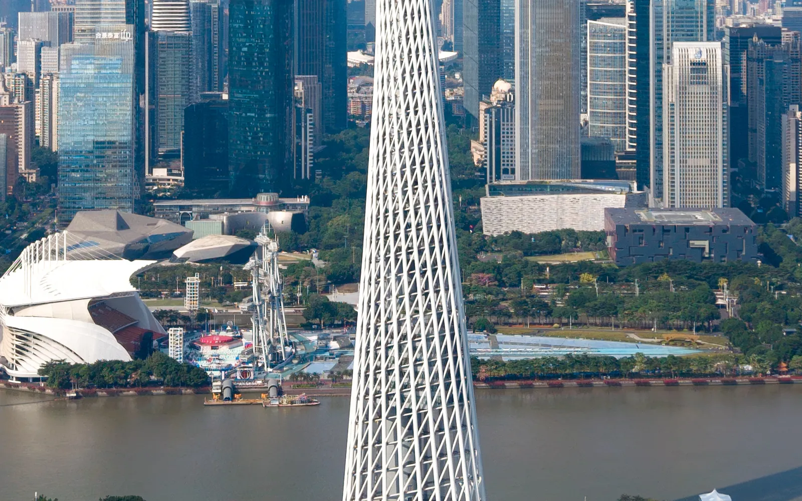The white, waisted Canton Tower standing 600 metres tall beside the Pearl River in Guangzhou