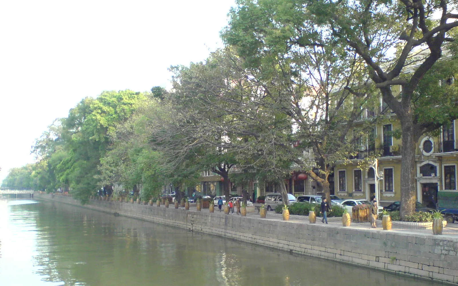 A street lined with large trees and cream-coloured European colonial buildings on Shamian Island, Guangzhou