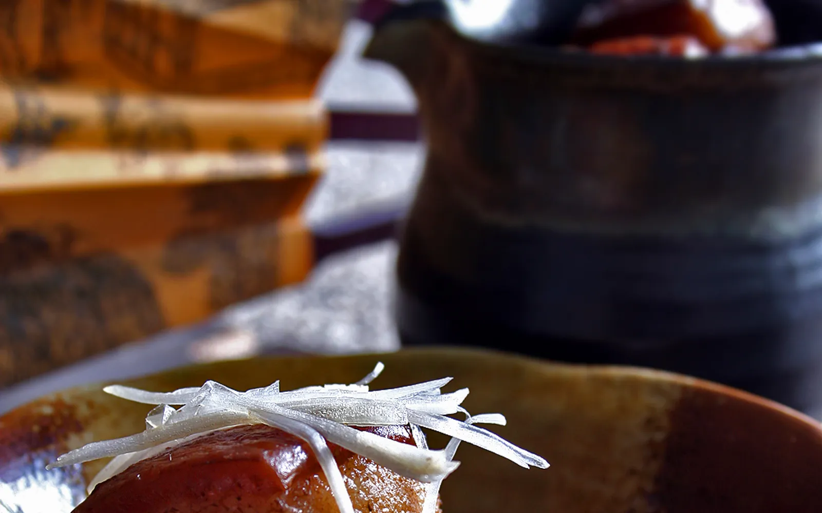 Glossy red-brown braised Dongpo pork belly in an earthenware pot, fragrant with oil and soy sauce