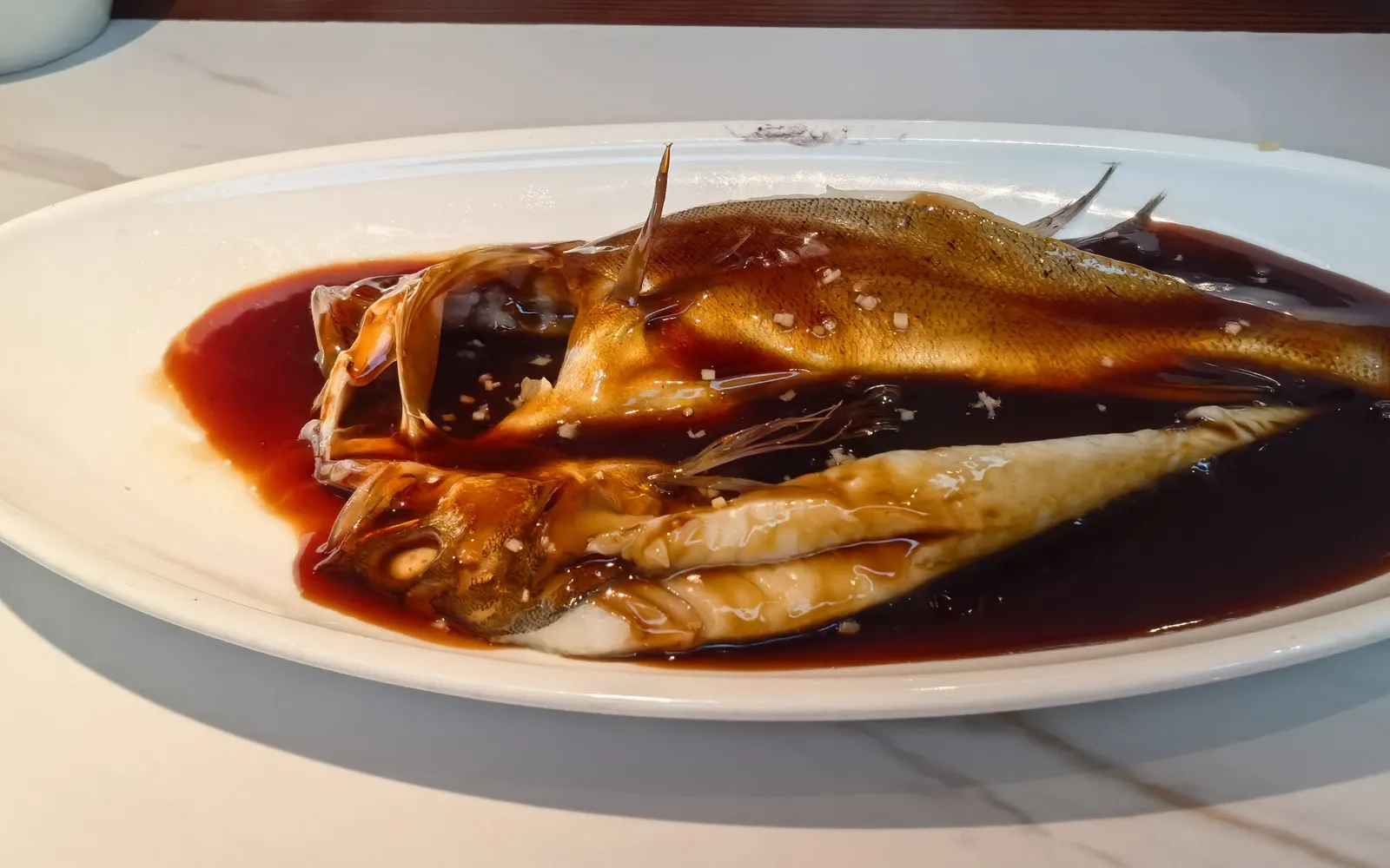 West Lake fish under a glossy red-brown vinegar sauce, plated and ready to serve