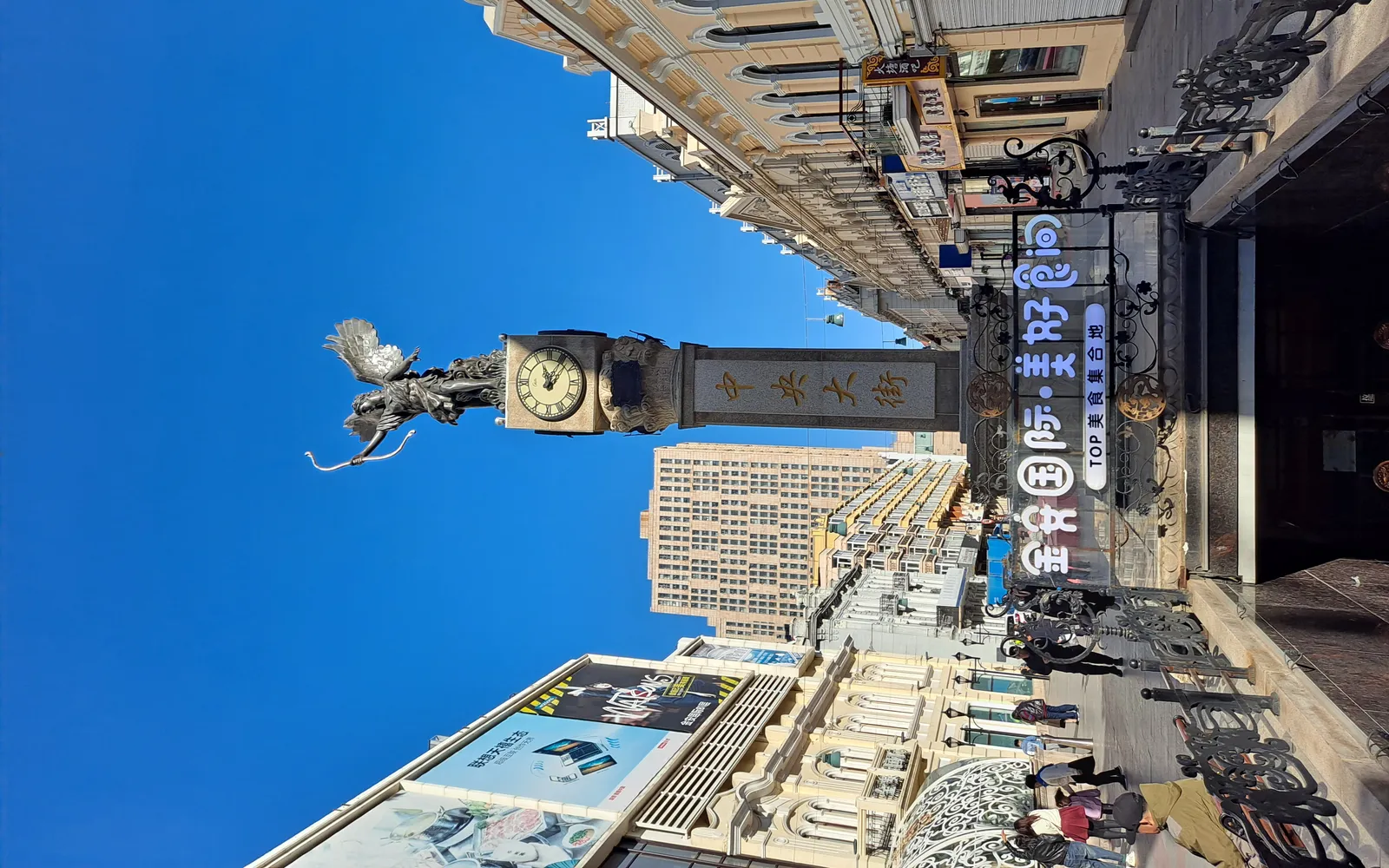 Harbin's Zhongyang Street paved with rounded cobblestones, early-20th-century European-style buildings on both sides, people strolling and eating ice cream in the cold