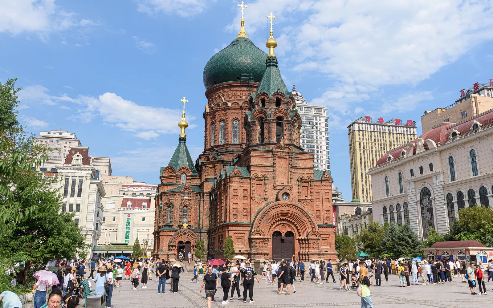 Saint Sophia Cathedral in Harbin, its large green-gold onion dome rising over a red-brick Russian-Byzantine building amid white snow