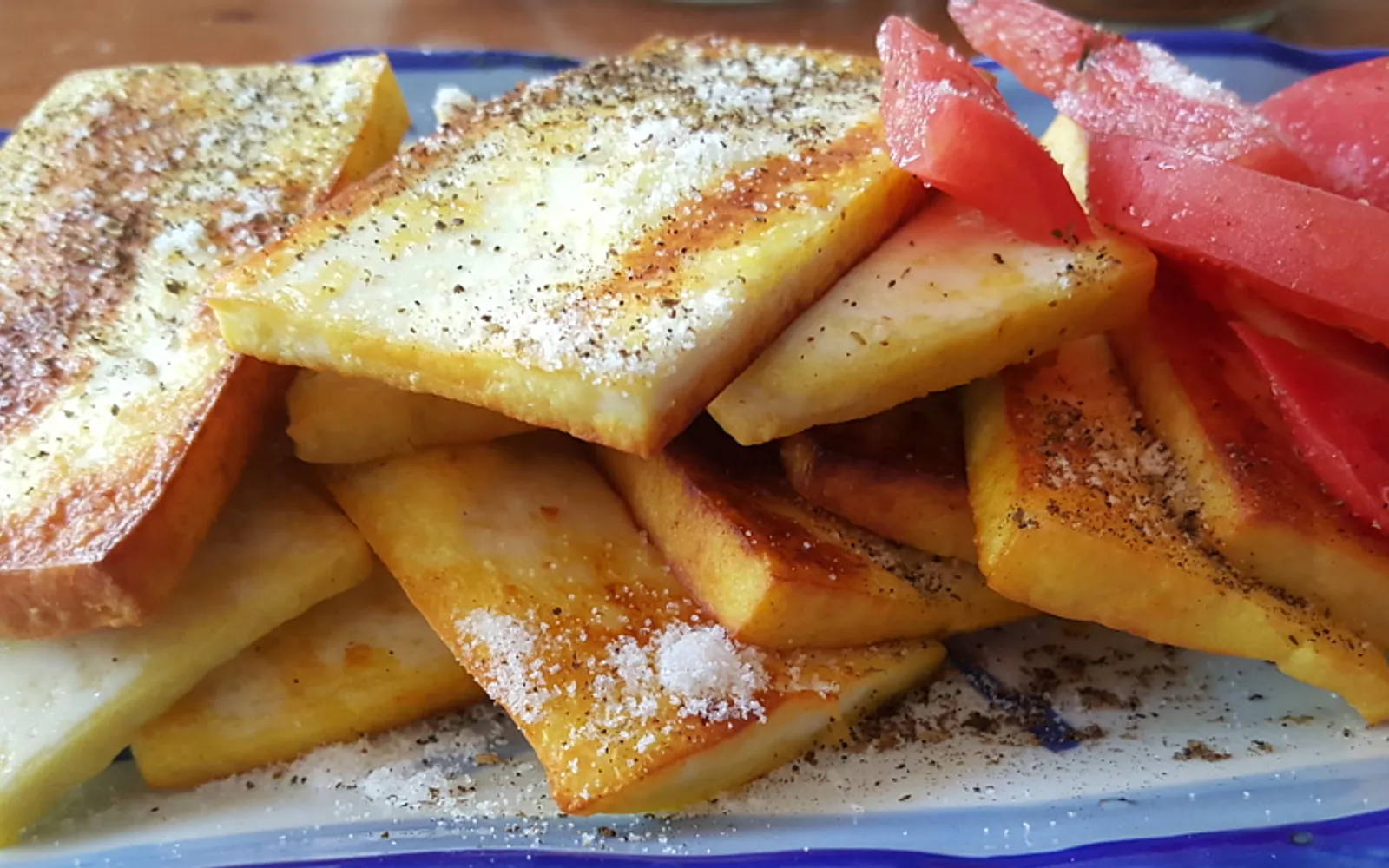 Golden fried Rubing milk cheese cut into sticks, topped with chili sauce, Lijiang