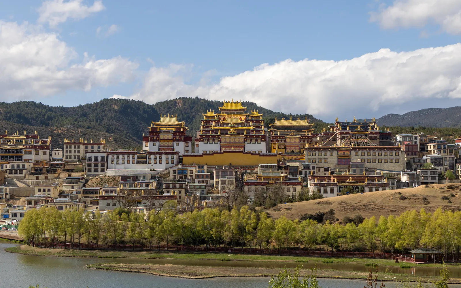 The Balagezong Grand Canyon — steep red-orange cliffs beside the emerald Gangqu River