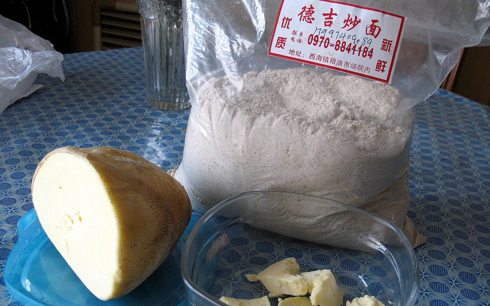Pale brown balls of roasted barley tsampa dough set on a wooden tray in a Tibetan home