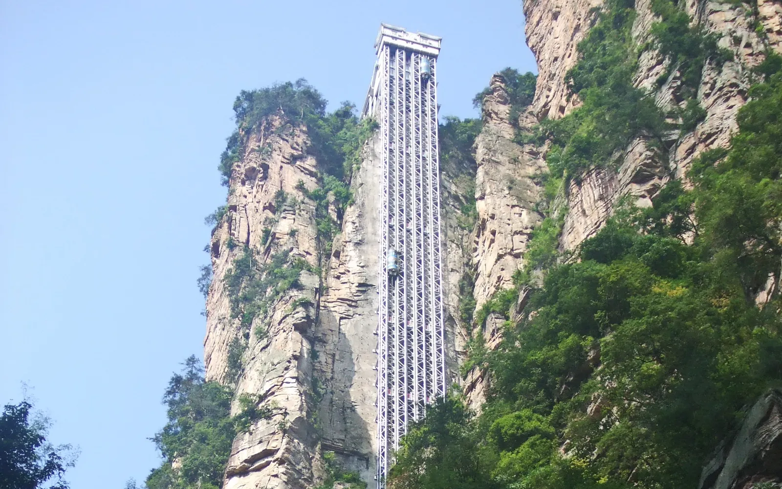 The Bailong glass elevator rising 326 metres against a sheer sandstone cliff inside Zhangjiajie park