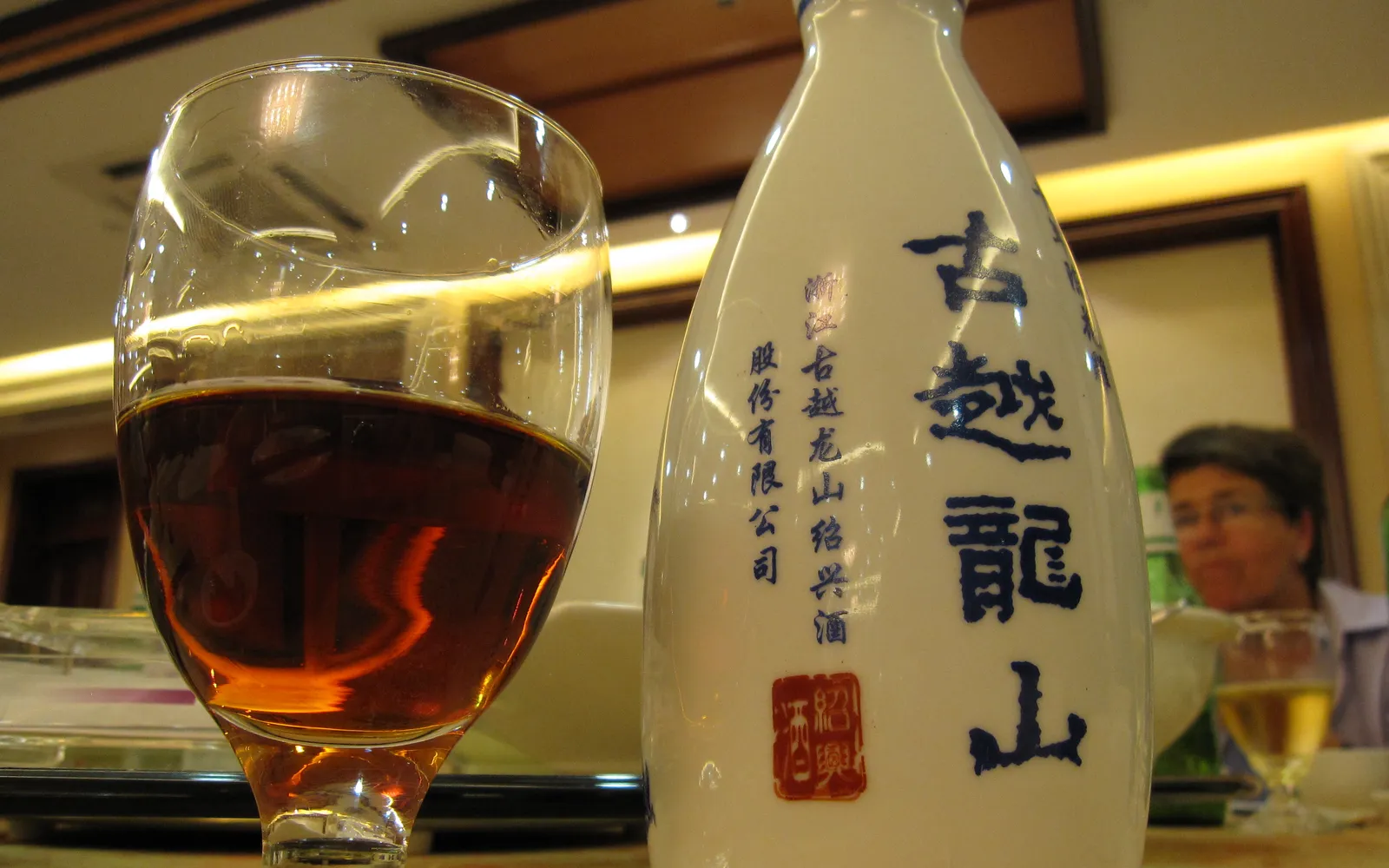 Milky white Tujia glutinous rice wine in a traditional clay pot, Zhangjiajie