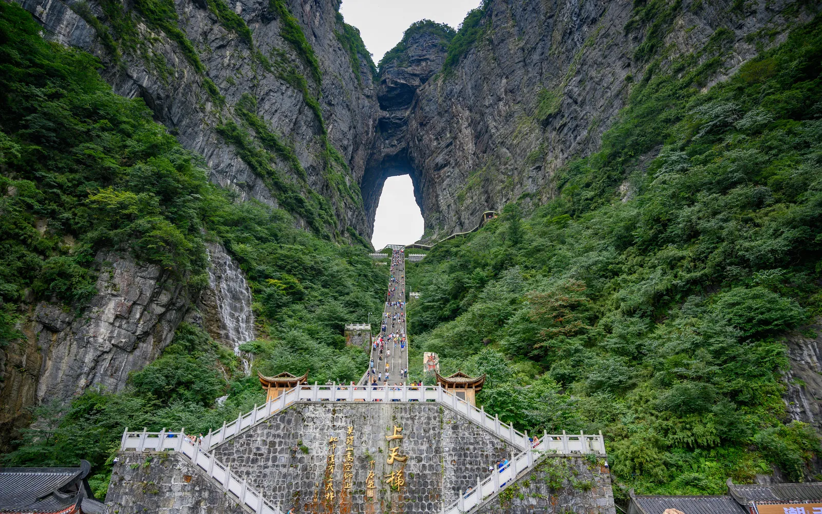 Heaven's Gate arch on Tianmen Mountain and the glass-bottomed skywalk clinging to the sheer cliff face, Zhangjiajie
