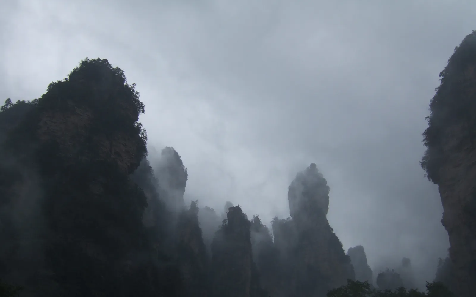 Thousands of sandstone pillars soaring above a sea of cloud, seen from the summit of Tianzi Mountain in Zhangjiajie