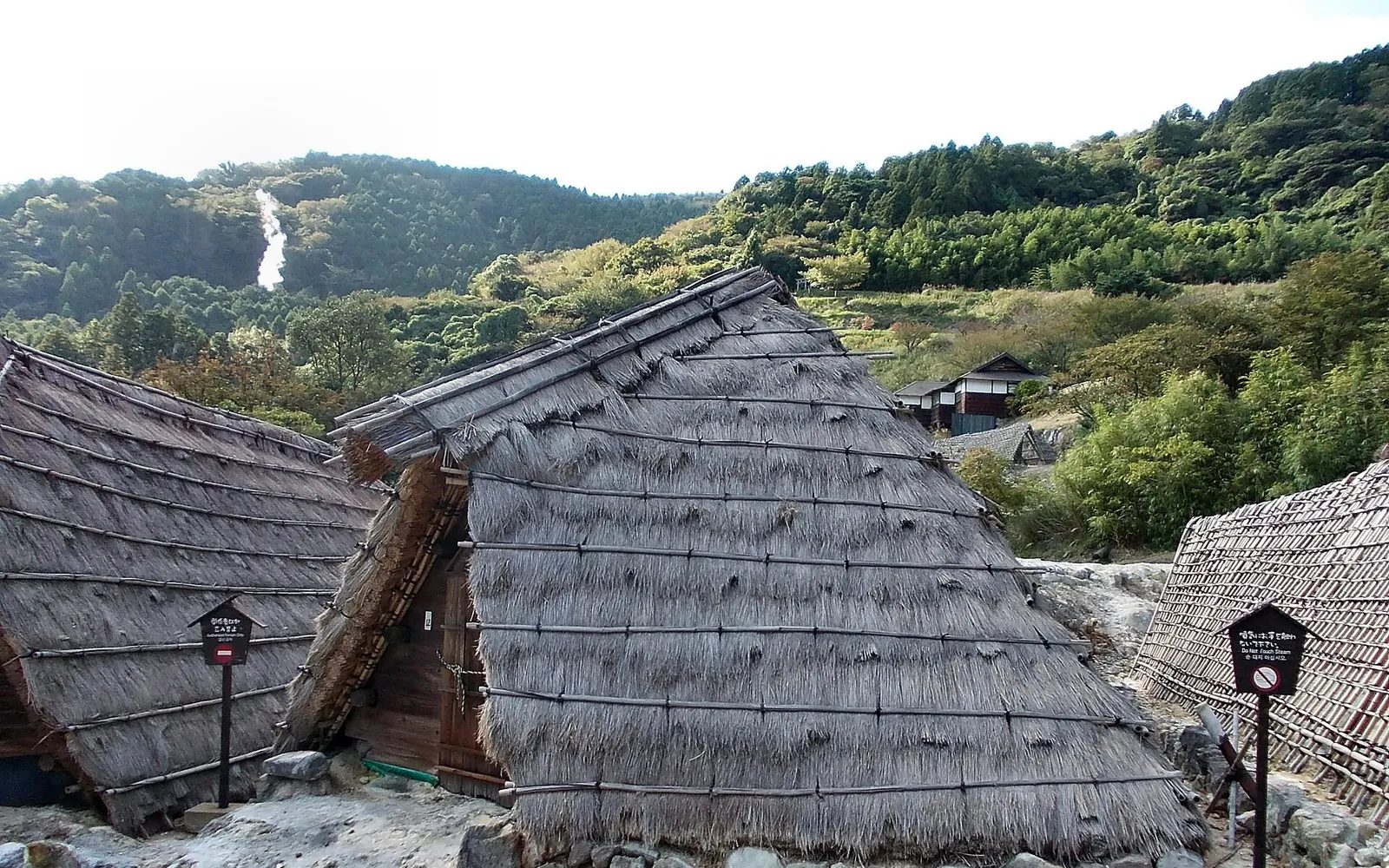 Yunohana-goya thatched huts at Myoban with sulfur steam drifting around them