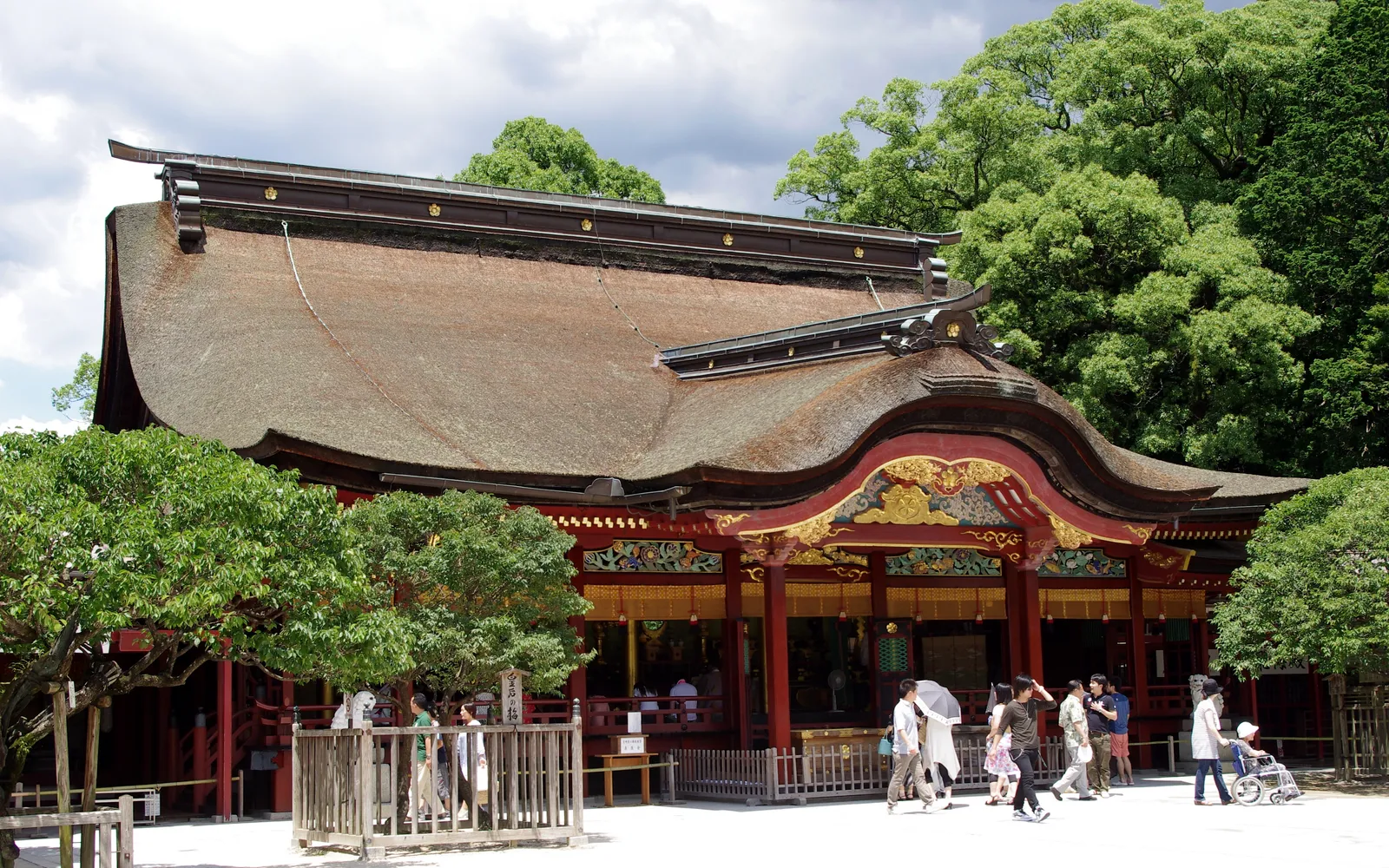 Arched bridge and torii gate at Dazaifu Tenmangu Shrine, surrounded by plum trees