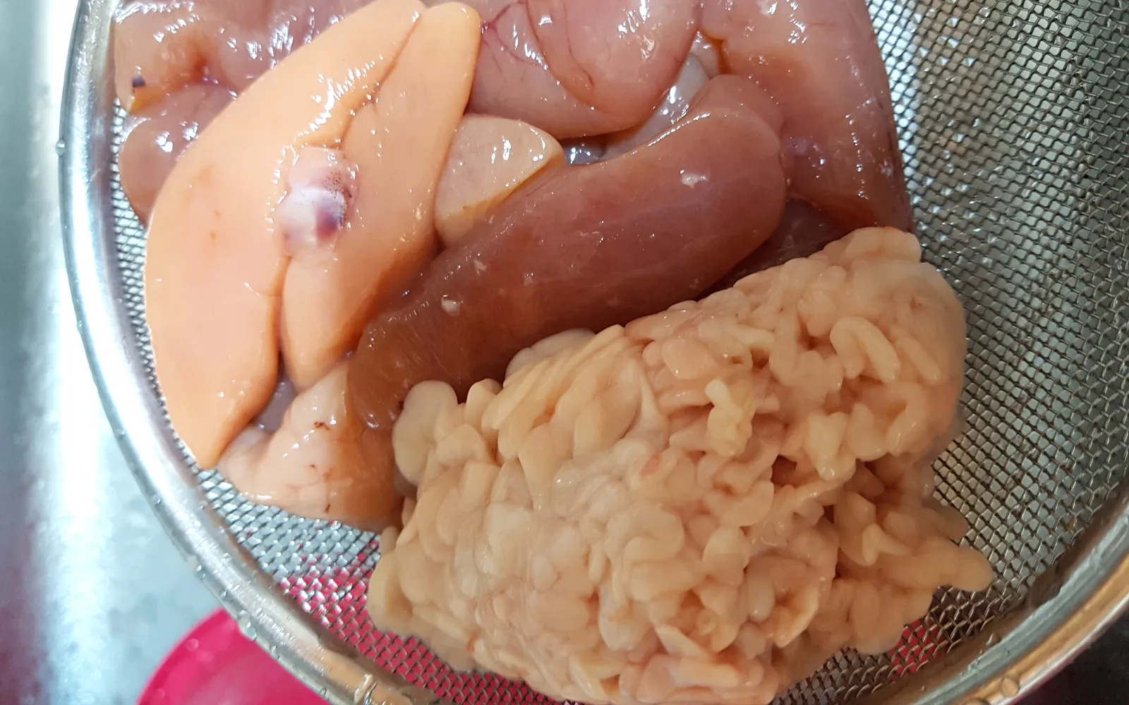 Bright pink mentaiko — spicy marinated cod roe — served in a dish alongside warm rice