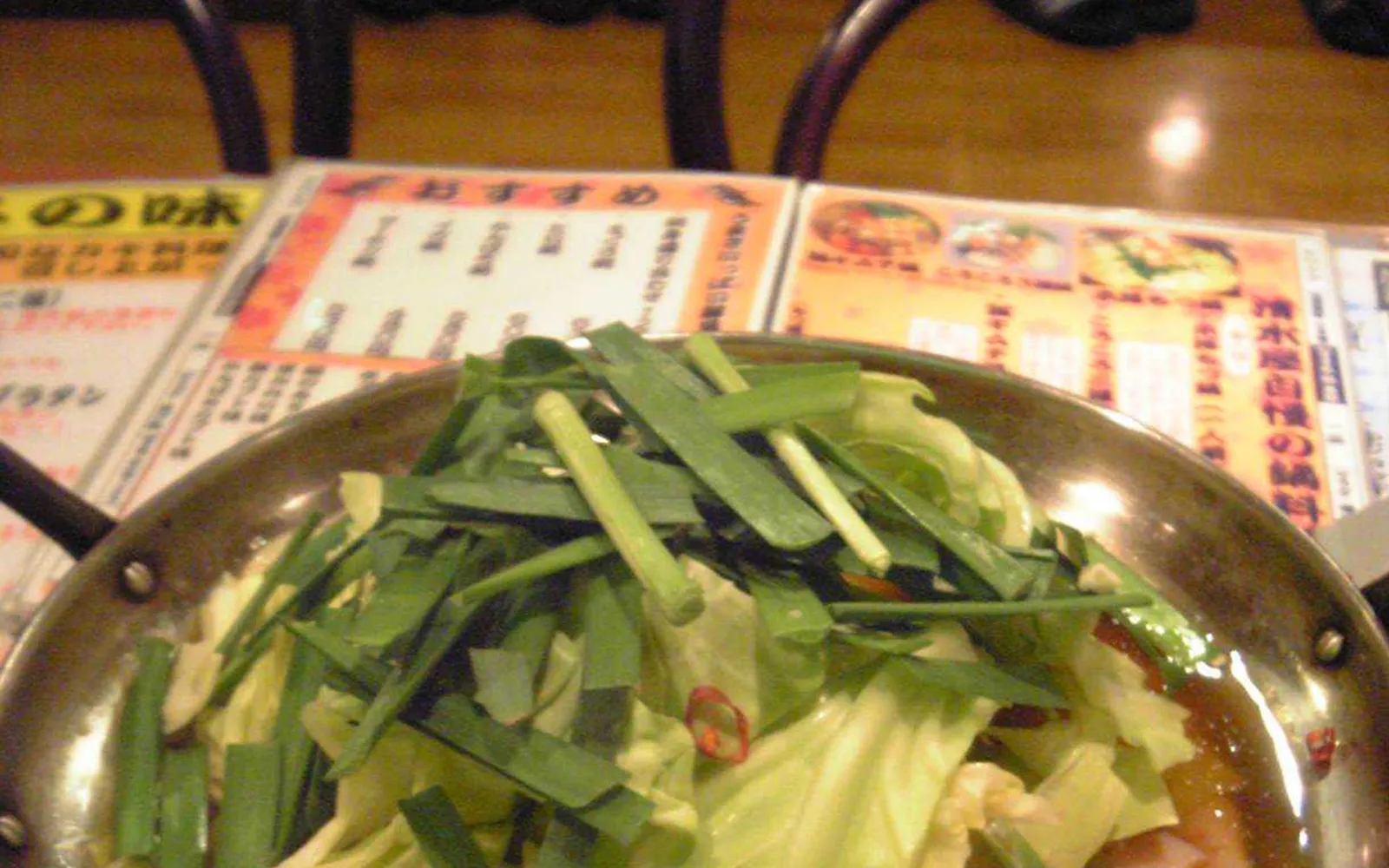 A bubbling motsunabe hot pot packed with offal, cabbage, and green onion