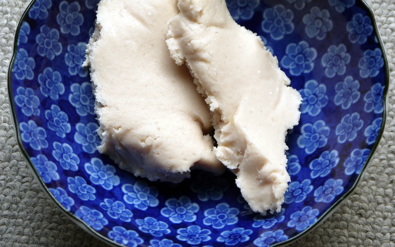 A warm bowl of milky-white kasujiru soup with pieces of vegetable and salmon floating on top