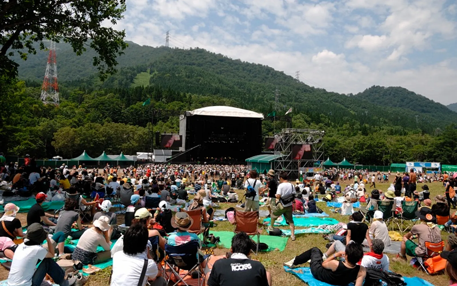The main Green Stage at Fuji Rock Festival set against lush mountain forest at Naeba