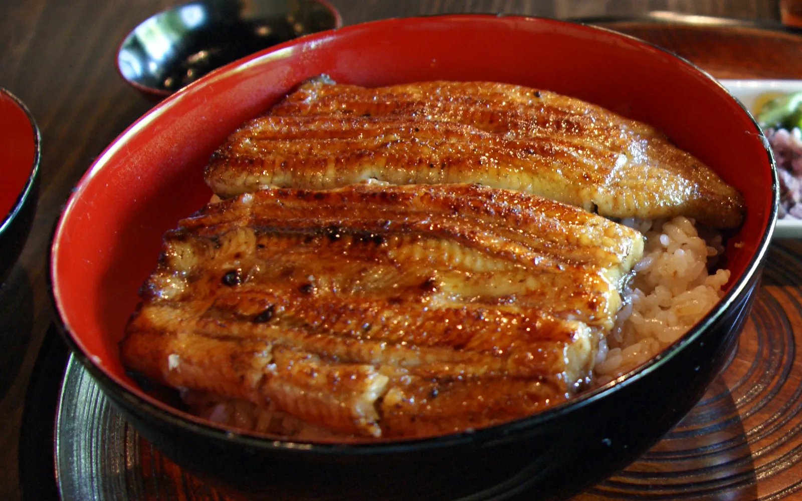 Unaju — grilled eel over rice served in a glossy black lacquer box, glazed with sweet-savoury tare sauce
