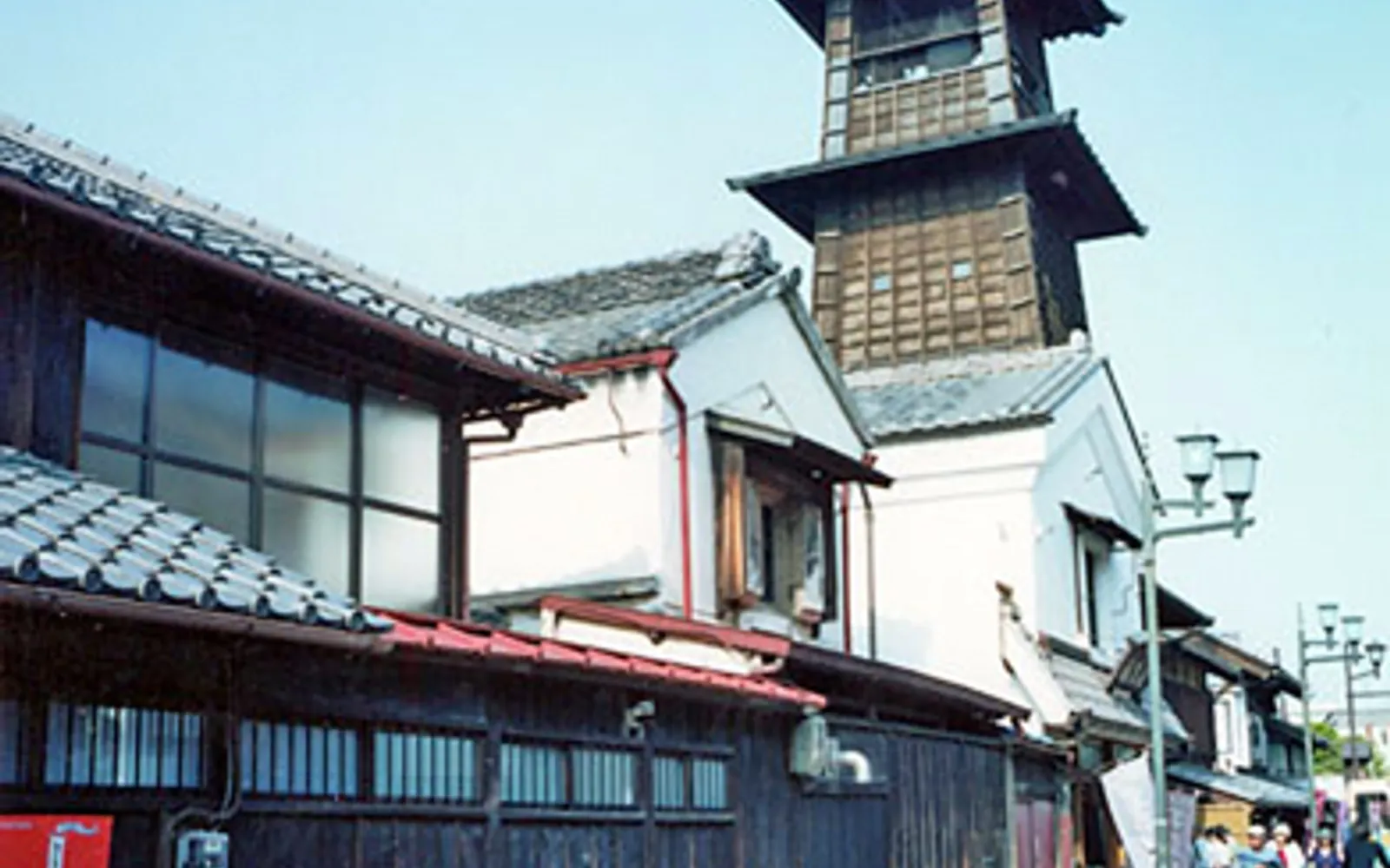 The 16-metre Toki no Kane bell tower built from dark wood, standing prominently in the middle of Kawagoe's warehouse district