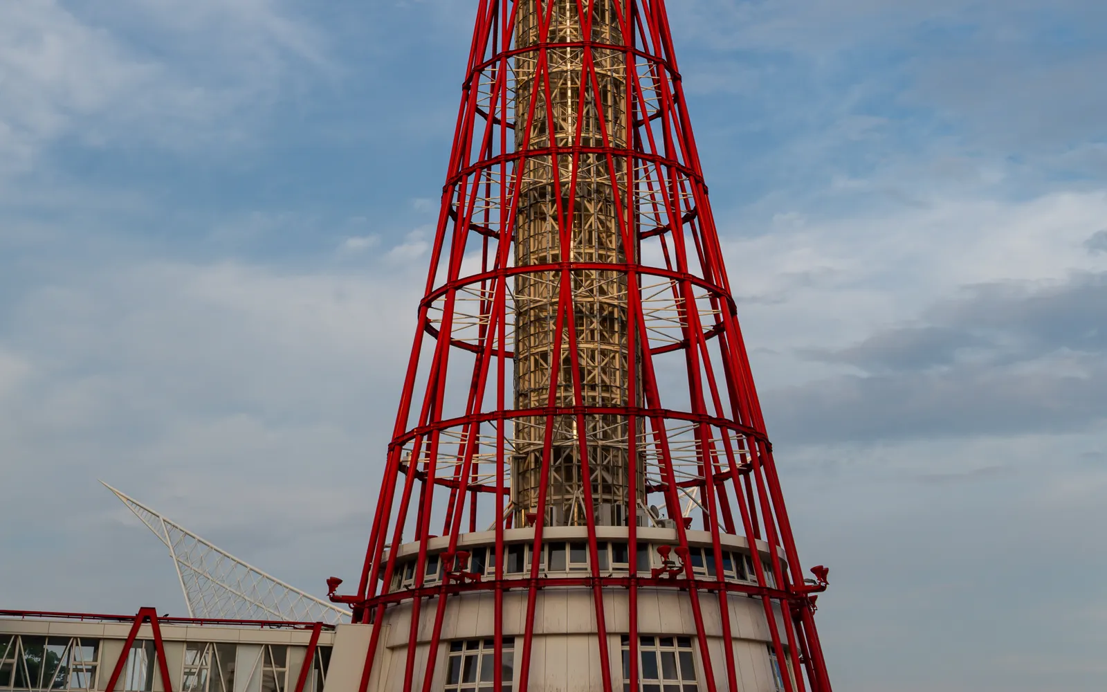 Kobe Port Tower, 108 metres tall, its red steel lattice structure shaped like a tsuzumi drum, standing in Meriken Park