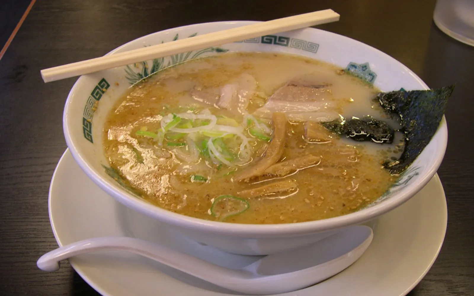 Kumamoto ramen with cloudy white broth and crispy fried garlic on top