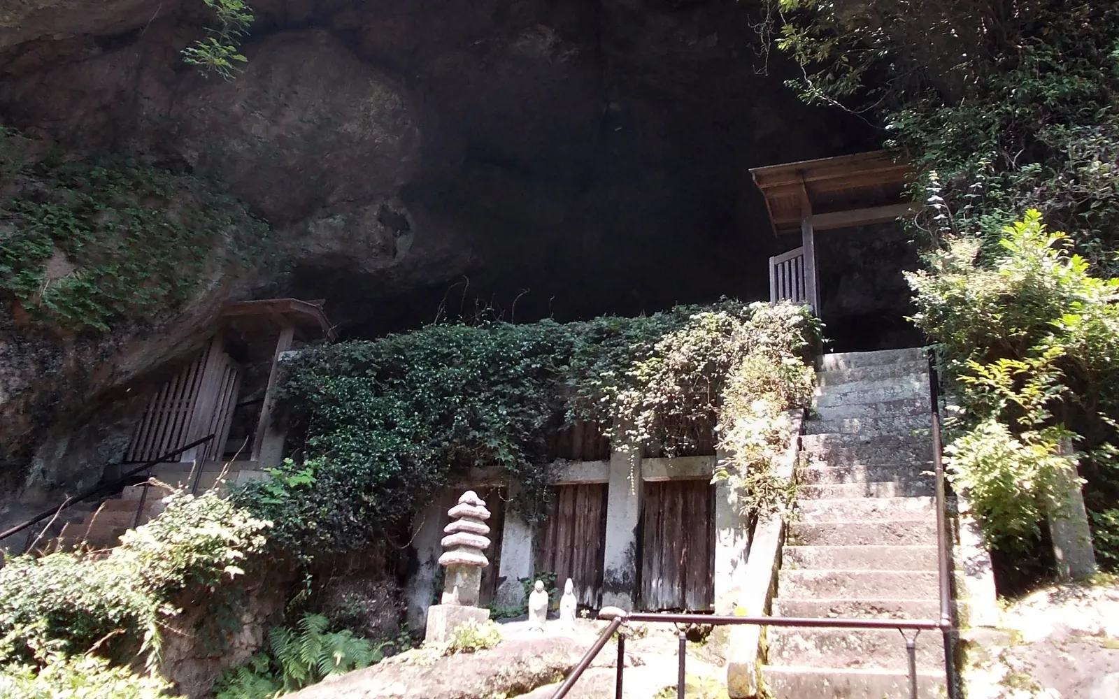 Stone steps leading up through trees to Reigando Cave at Unganzenji Temple