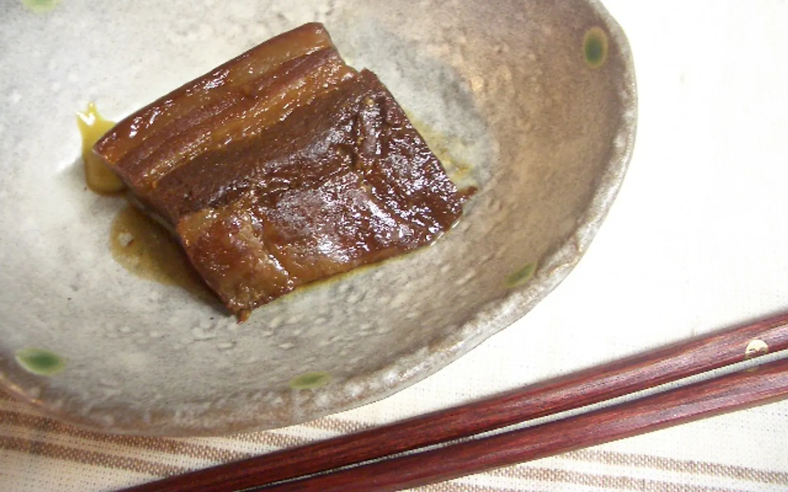 A steamed white bun filled with braised pork belly — slow-cooked until meltingly tender — one of Nagasaki's signature street snacks