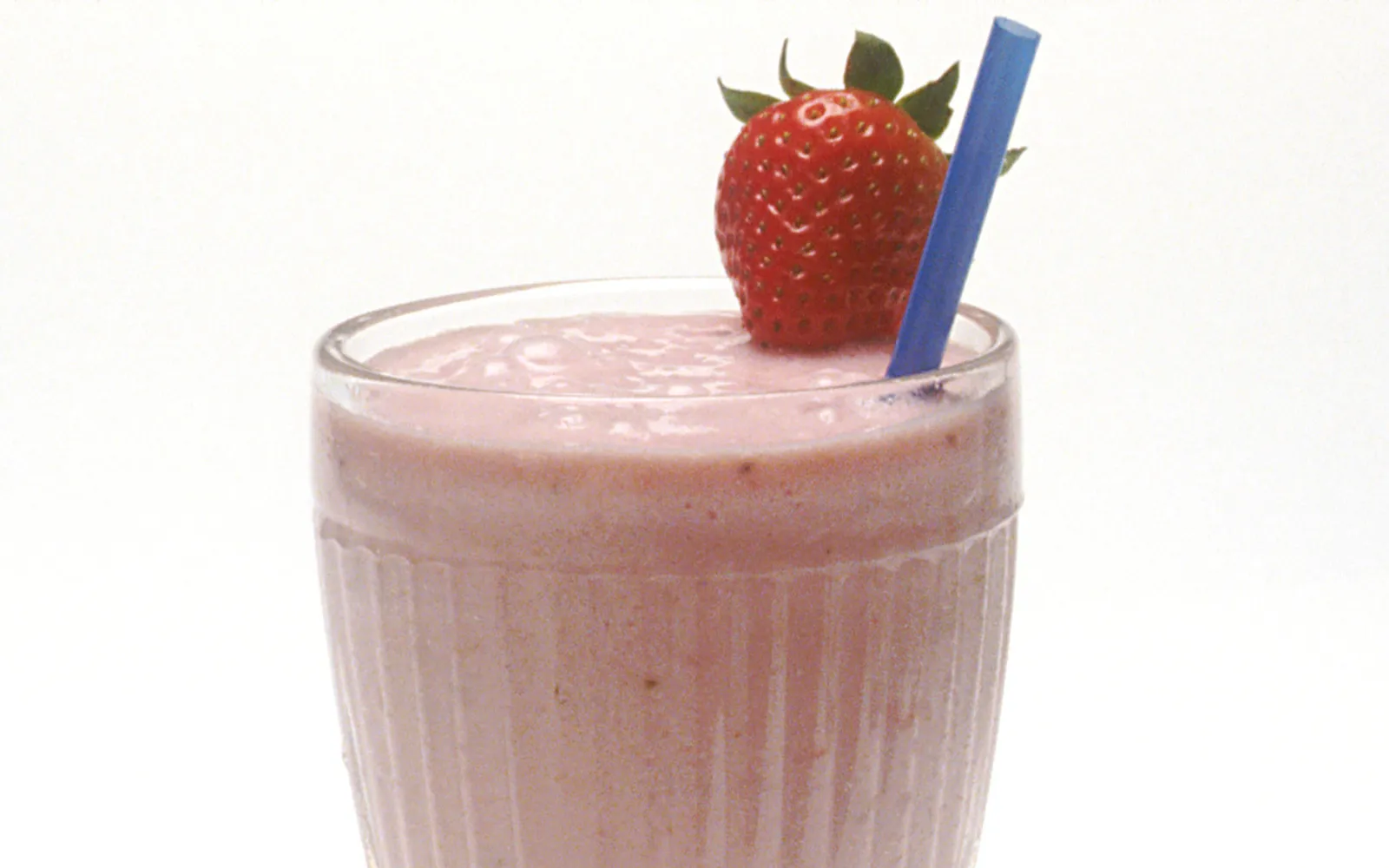 A glass of traditional Nagasaki milkshake — dense, cold ice cream consistency topped with a maraschino cherry