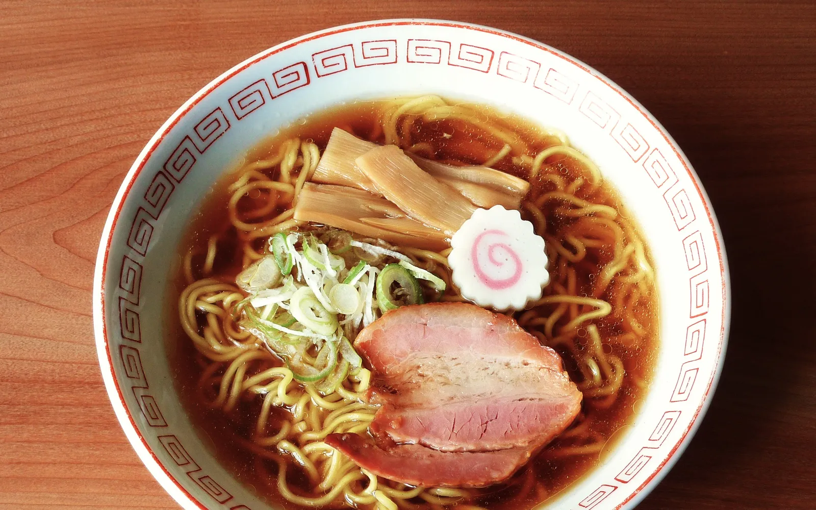 A steaming bowl of Hokkaido miso ramen with a pat of butter melting over sweet corn — rich, deep-colored broth