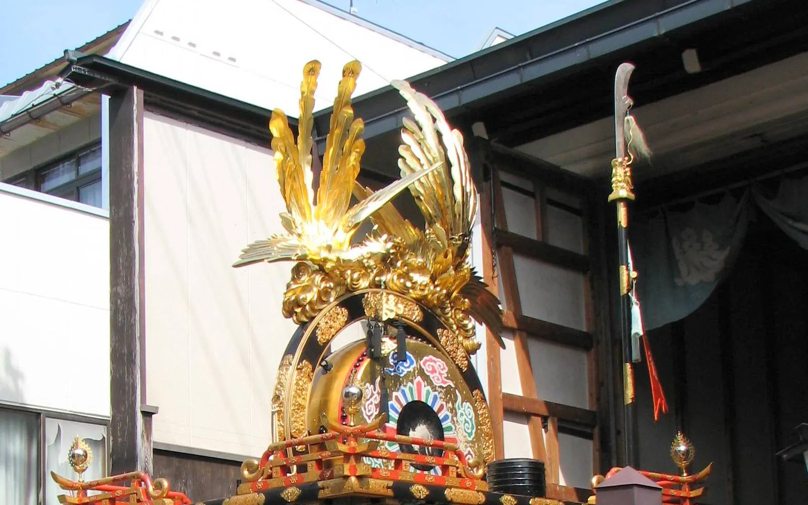 Massive gilded and intricately carved yatai festival float displayed inside Yatai Kaikan hall