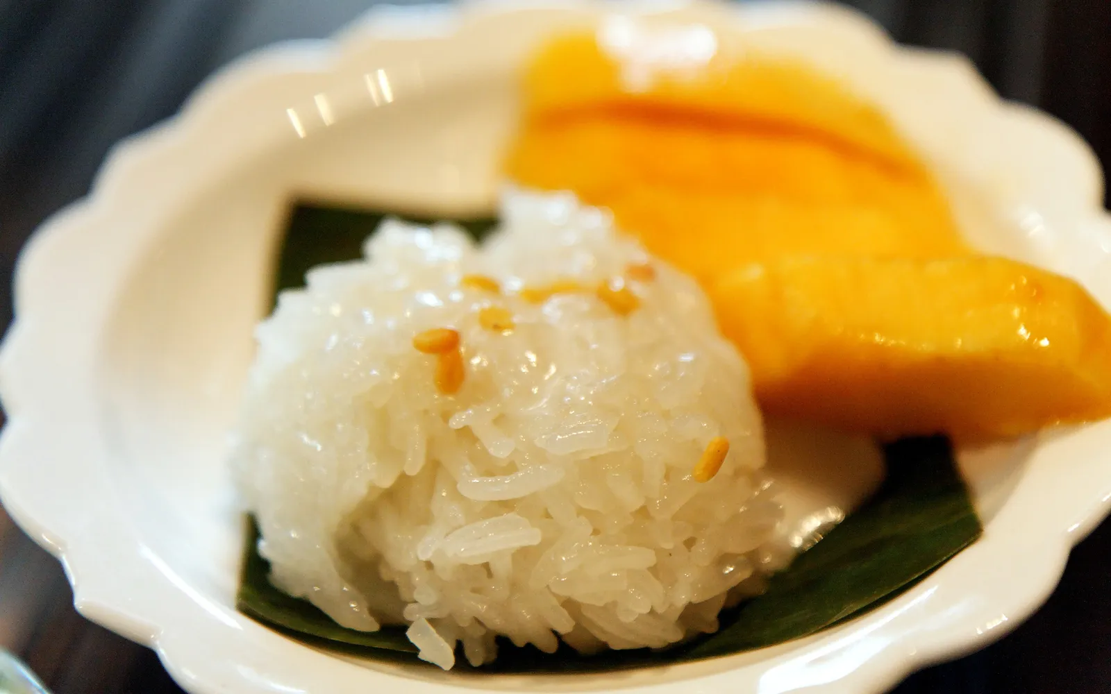Mango Sticky Rice — creamy white coconut-soaked glutinous rice alongside vivid yellow Nam Dok Mai mango slices