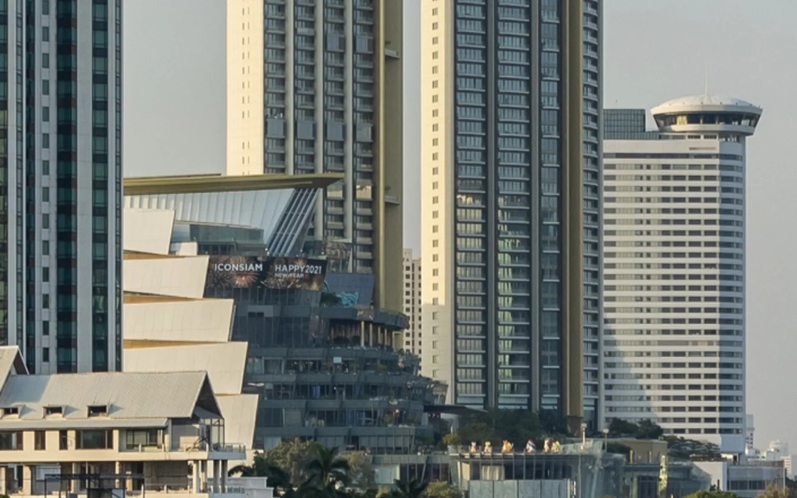 ICONSIAM on the Chao Phraya River at night, lights reflected on the water against the Bangkok skyline