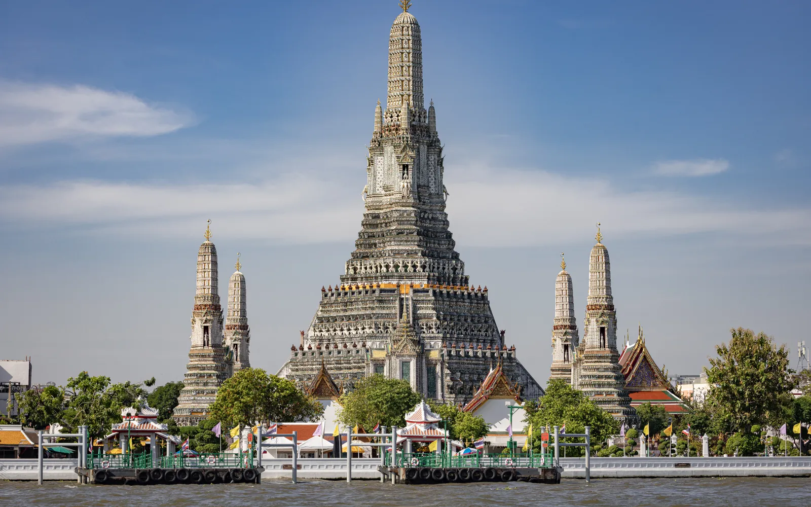 The central prang of Wat Arun covered in shell and ceramic fragments in many colors, on the bank of the Chao Phraya River in Bangkok
