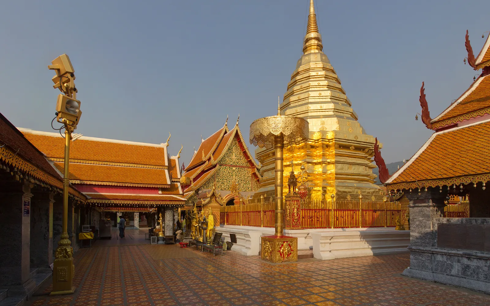 The golden chedi of Wat Phra That Doi Suthep rising through thin morning mist