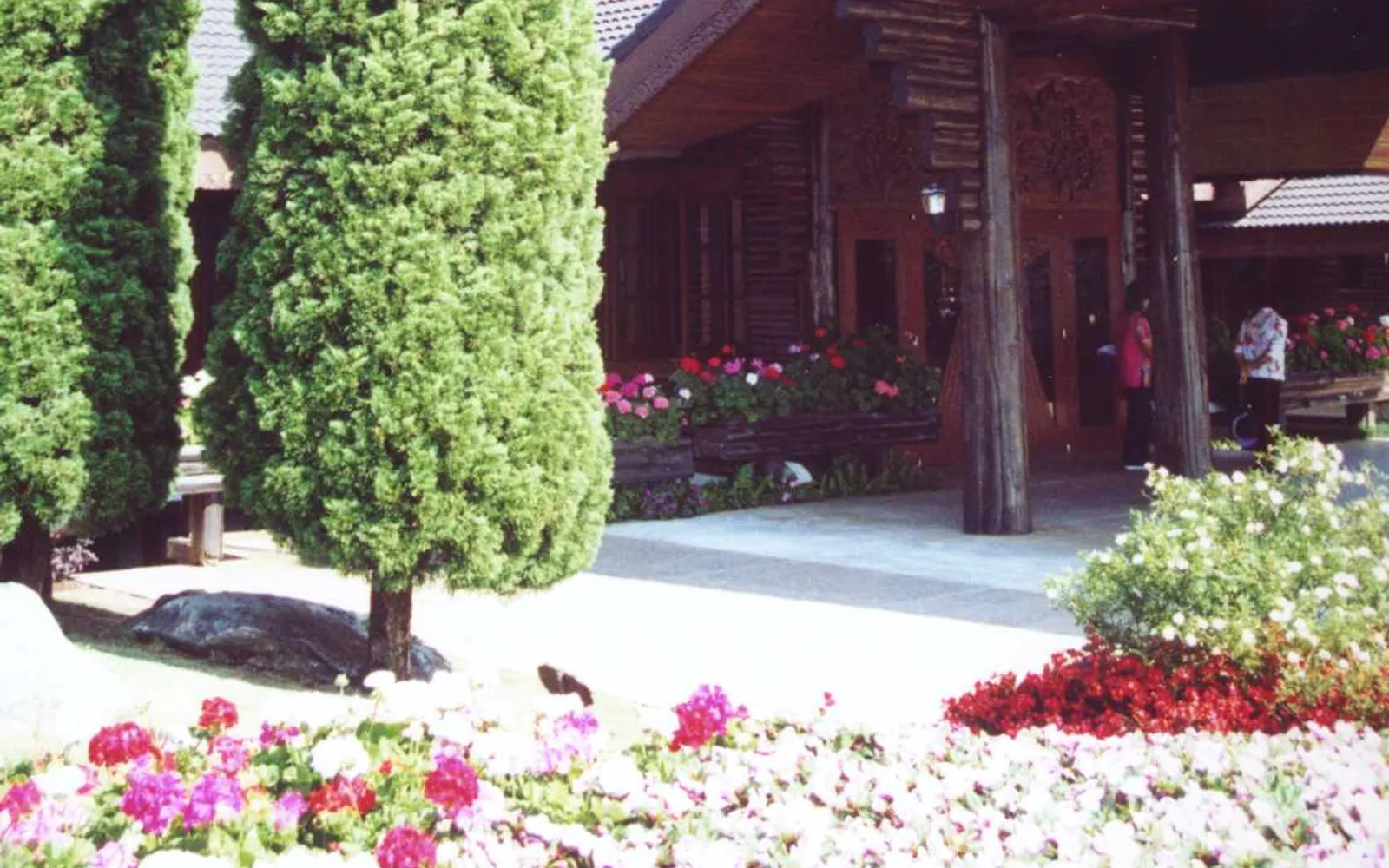 Doi Tung Royal Villa on the summit — Lanna-Swiss style buildings surrounded by colourful flower gardens