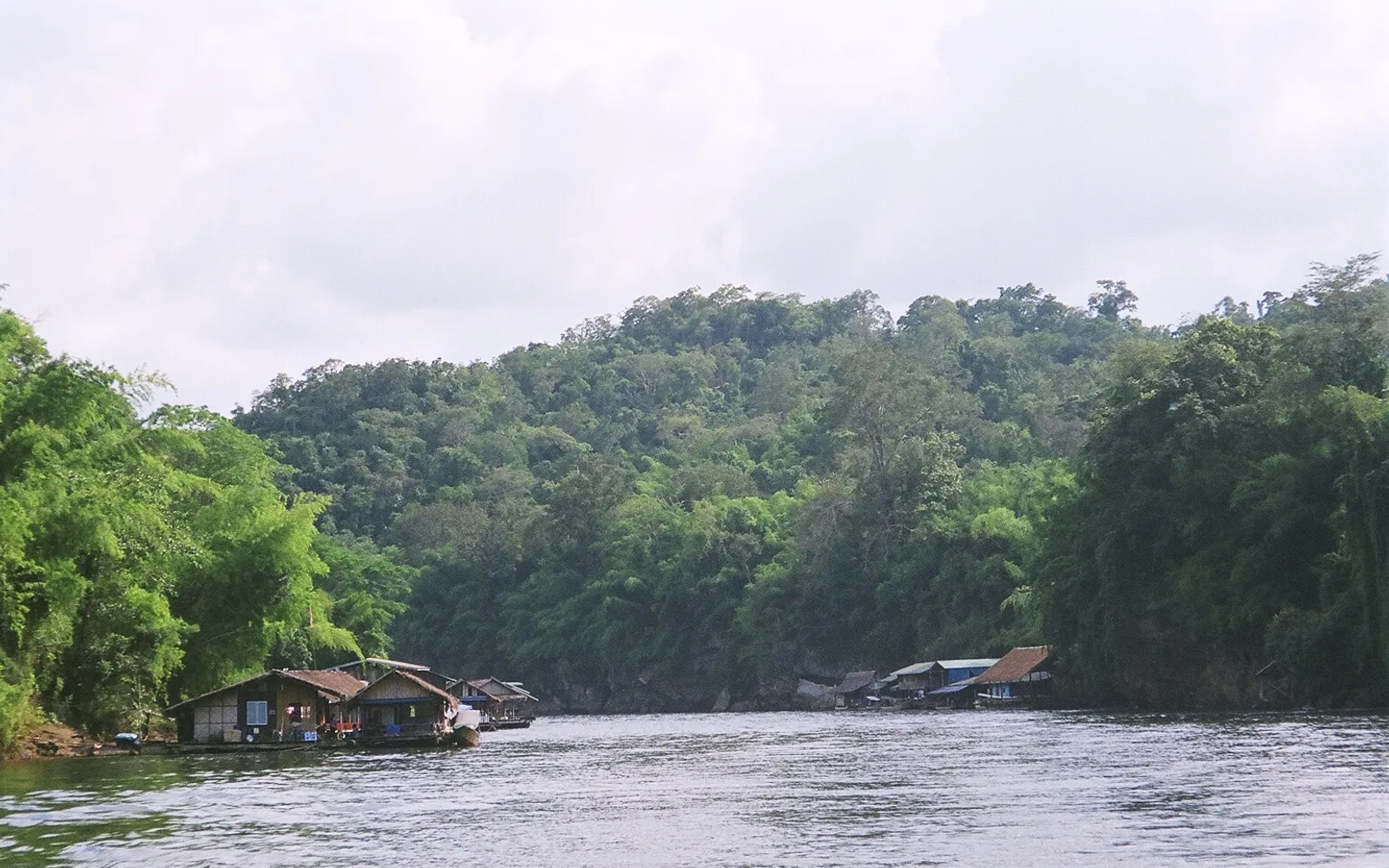 Sai Yok Noi waterfall spilling into the Khwae Noi River amid green forested hills