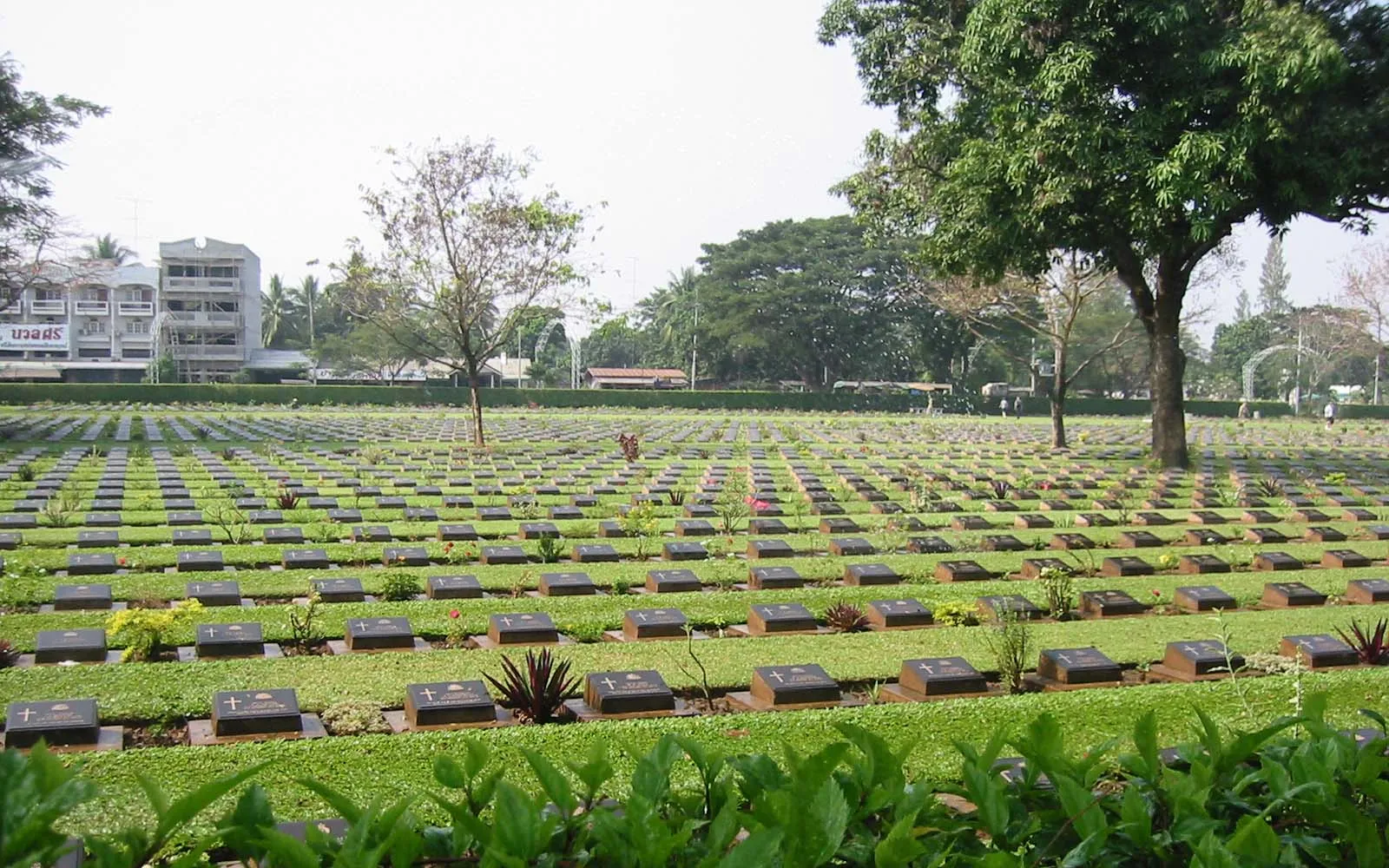 Kanchanaburi War Cemetery — neat rows of graves set in a tidy green garden