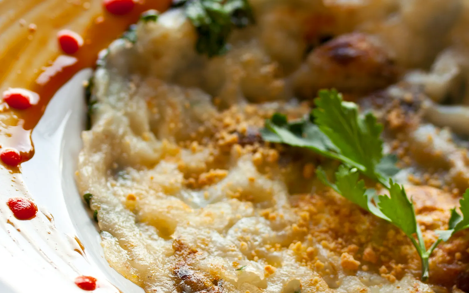 Thai hoi tod — egg and tapioca batter fried until the edges are crispy and the centre stays soft and chewy, topped with fresh oysters and bean sprouts, served with sweet chilli sauce