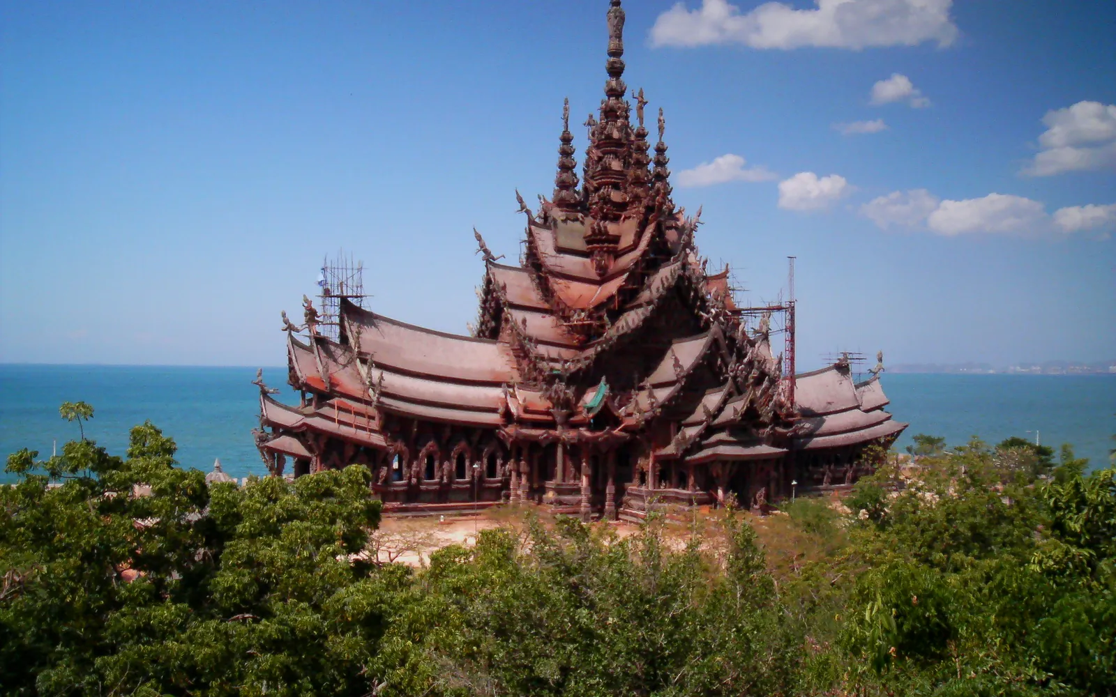 The Sanctuary of Truth in Pattaya — a 105-metre teak structure built without a single nail, covered in hand-carved Hindu and Buddhist deities along the Gulf of Thailand shoreline