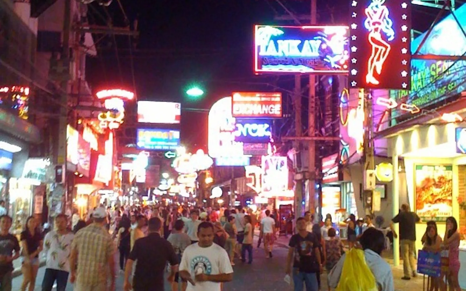Pattaya Walking Street at night — neon signs blazing across 1 kilometre of road, with travelers from every country passing restaurants, bars, and entertainment venues